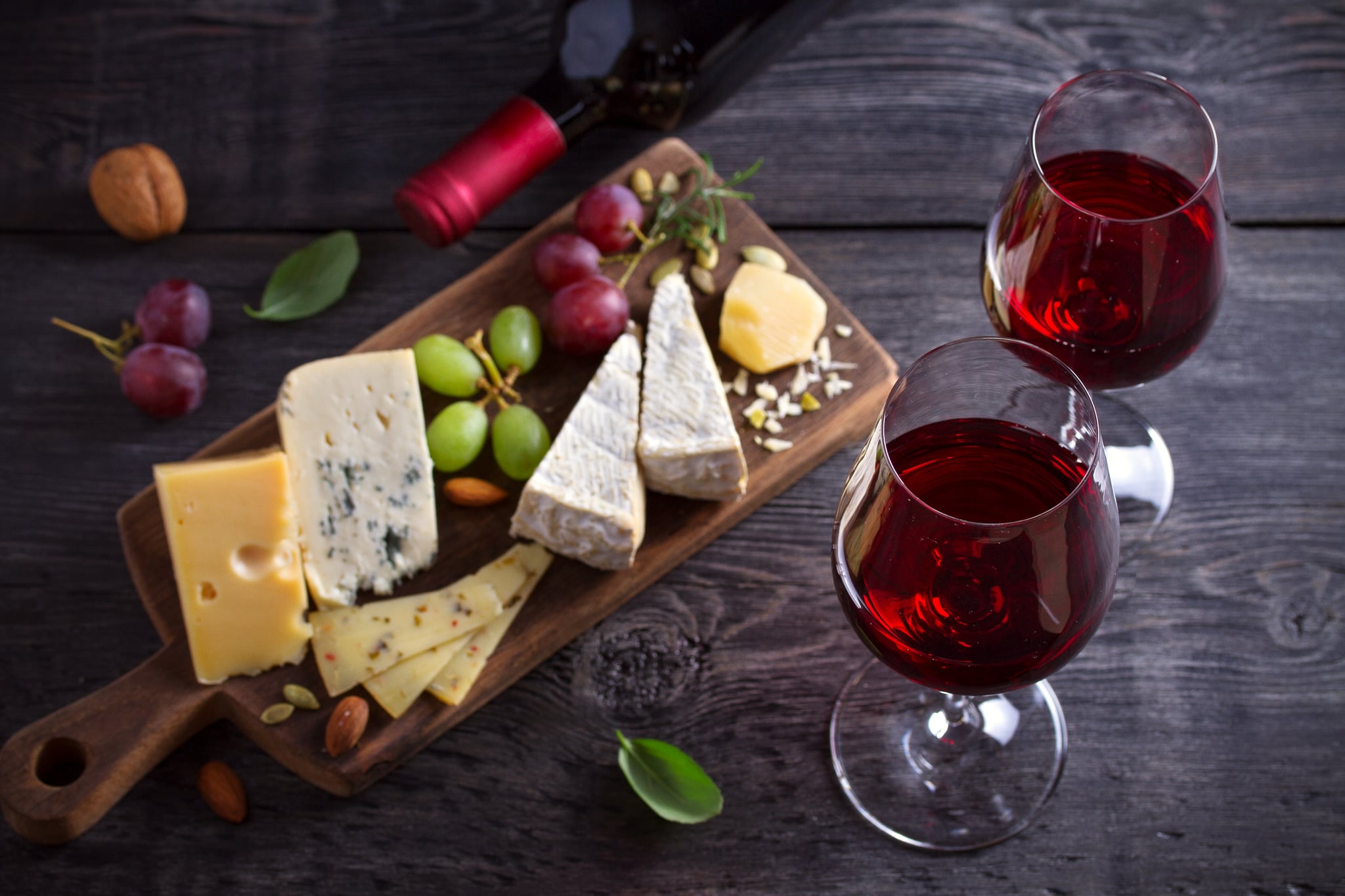 Red wine with cheese on chopping board. Wine and food concept - Image