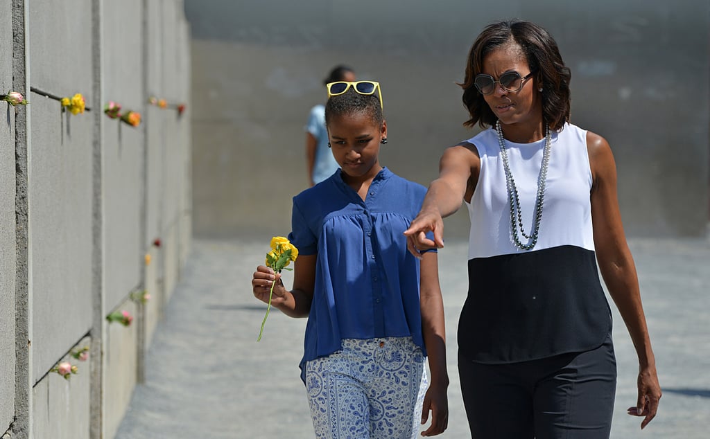 First Lady Michelle Obama visited the Berlin Wall in June 2013 with her daughters, Sasha and Malia.