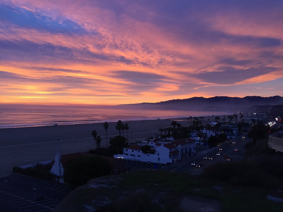 "Finding angles that create visual separation between different elements of a scene can help highlight their details. The sharp lines of the horizon, street, and shore draw the eye in for a closer look."