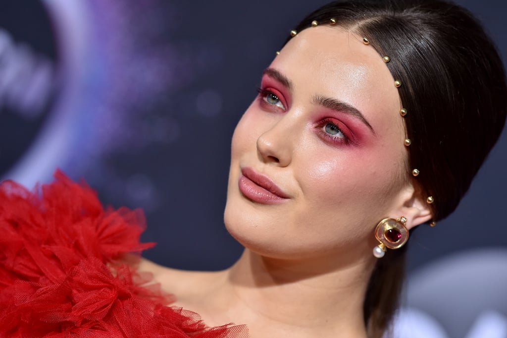 Katherine Langford was seeing red at the 2019 American Music Awards. The actress and Knives Out star matched her eye makeup to the fiery hue of her Rodarte dress, resulting in what has since been described as "red velvet eyes" by her makeup artist, Fiona Stiles. Langford's makeup was otherwise pretty simple, with just a pop of pink blush and neutral pink lipstick. 
Her hairstyle, however, was an entirely different story. Langford's long hair was gathered in a low ponytail with a subtle beehive at the back, and hairstylist Jenny Cho embellished the hairline with small gold beads resembling a modern interpretation of a crown. 
With Knives Out receiving some early award season buzz, we look forward to seeing more daring beauty looks from Langford at red carpet events to come. In the meantime, get a closer look at her AMAs hair and makeup ahead.

    Related:

            
            
                                    
                            

            ICYMI, These Were the Award-Winning Beauty Looks at the 2019 American Music Awards