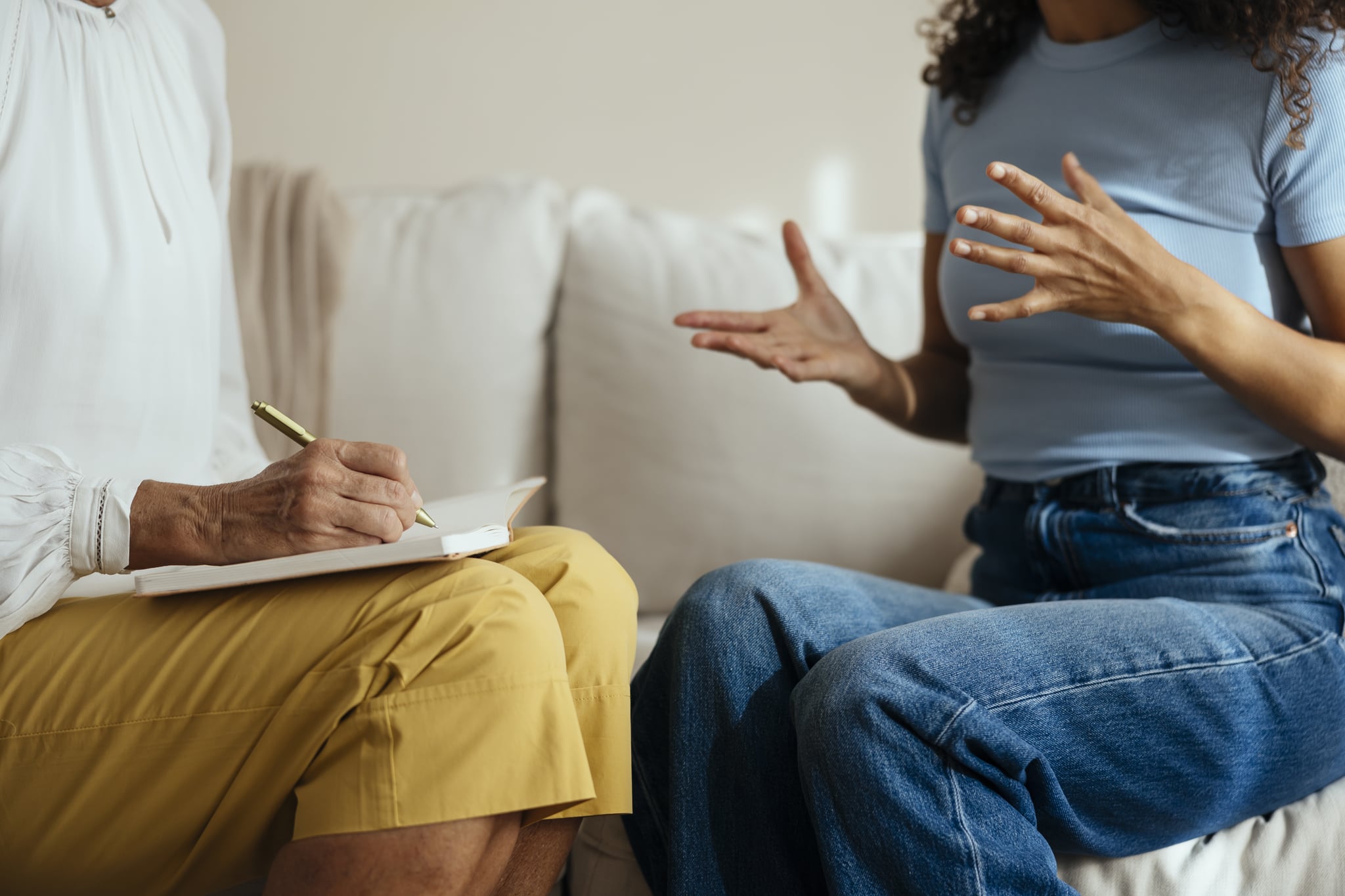 Woman sitting on the couch, talking to her therapist, trying to get the most out of therapy. Woman sitting on the couch, talking to her therapist, trying to get the most out of therapy.