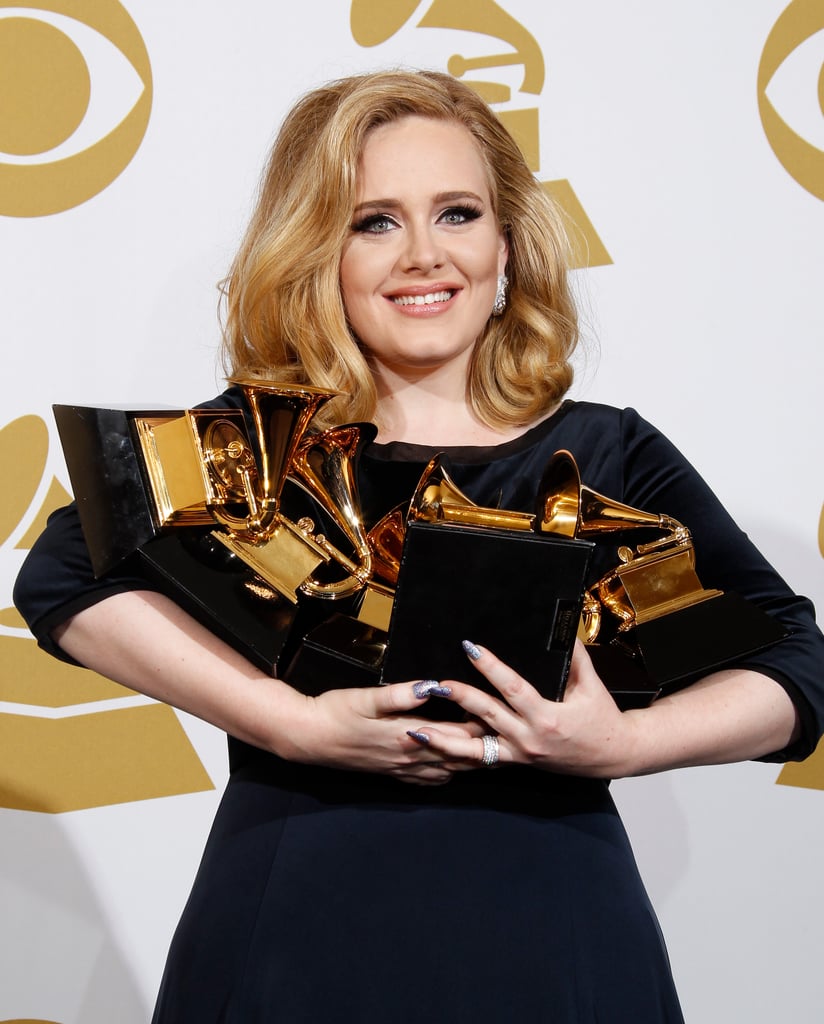 Adele held on to her Grammy Awards in the press room during the 2012