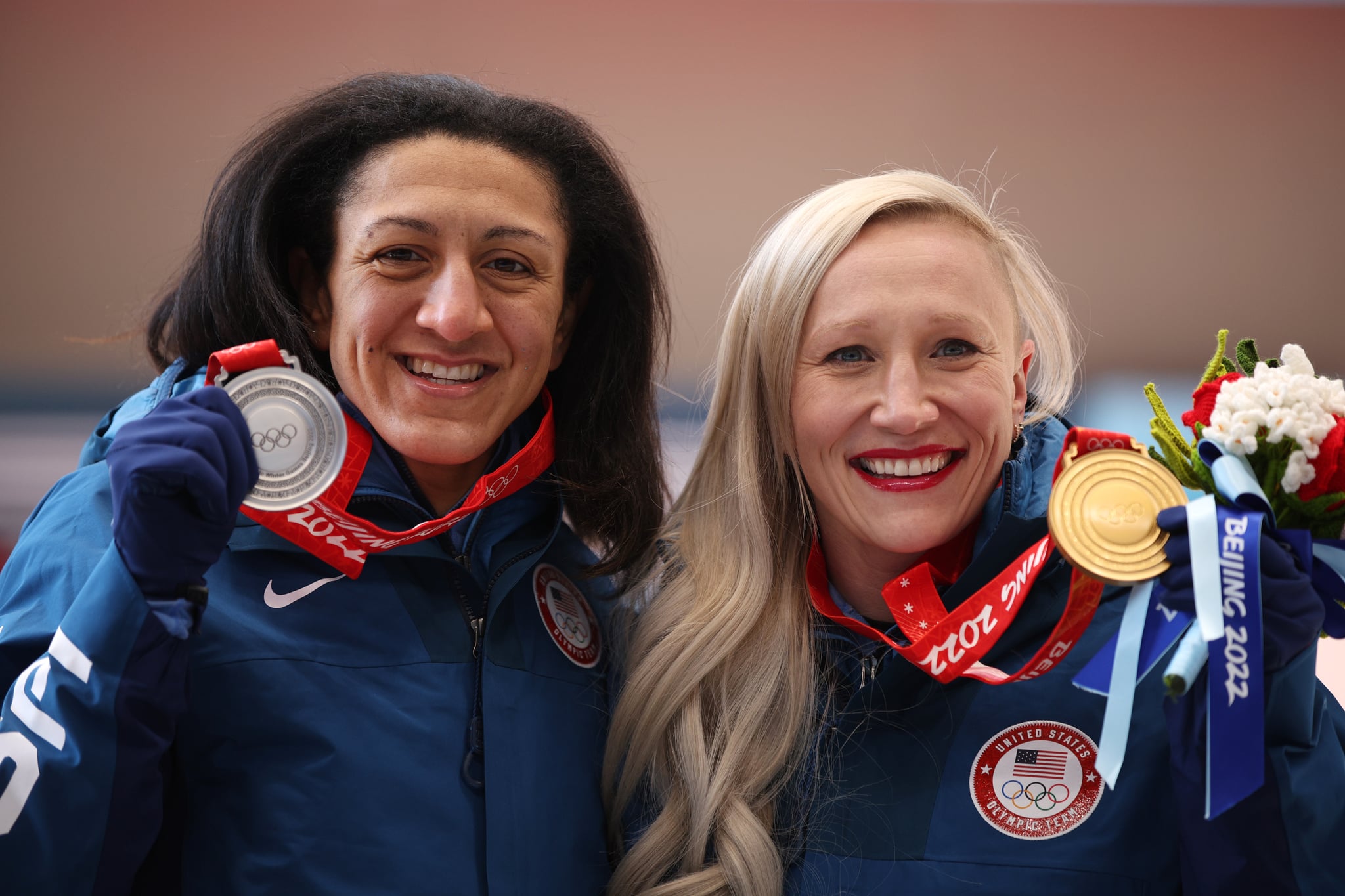YANQING, CHINA - FEBRUARY 14:  (L-R) Silver medallist Elana Meyers Taylor of Team United States and Gold medallist Kaillie Humphries of Team United States celebrate during the Women's Monobob medal ceremony on day 10 of Beijing 2022 Winter Olympic Games at National Sliding Centre on February 14, 2022 in Yanqing, China. (Photo by Adam Pretty/Getty Images)