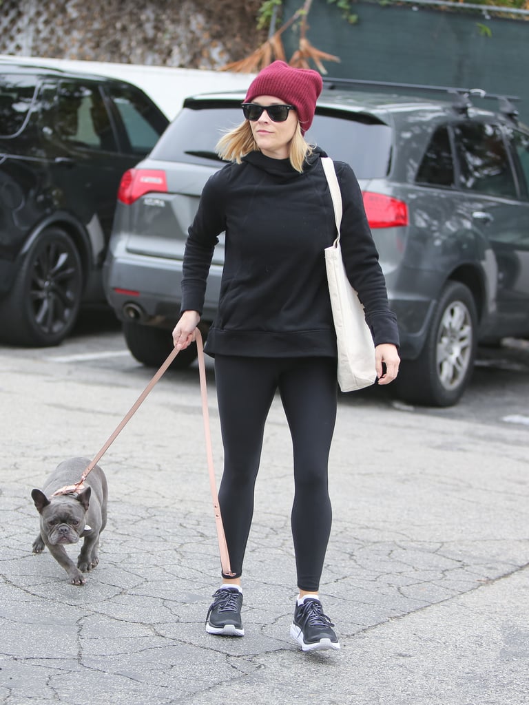 Reese loves to add a pop of color, like this sporty outfit paired with a red beanie.