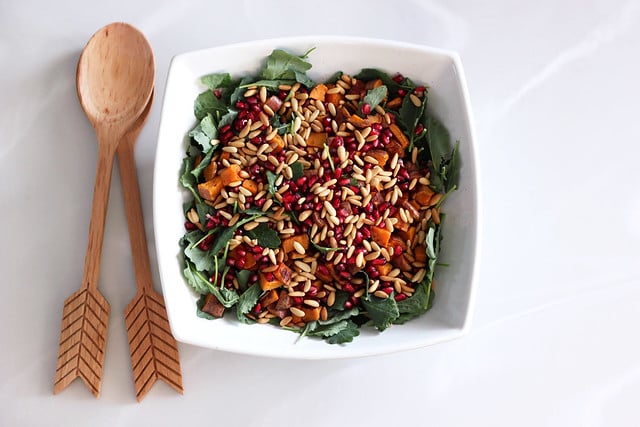 Baby Kale and Roasted Sweet Potato Salad With Pomegranate and Toasted Pine Nuts