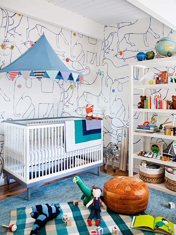 Nicole would appreciate the beams on the ceiling, and a baby would love the sensory delights of this nursery — from the canopy/campaign tent trimmed with multicolored, printed flags to the earthy Moroccan-style leather pouf. The basic bookcase does double duty with the help of lined baskets and stores not only picture books, but also toys, clothing, and anything a busy mom needs to have on hand.