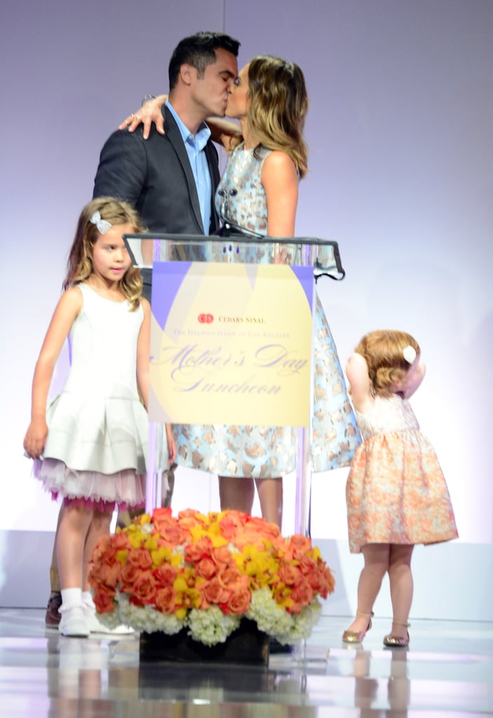 Jessica and Cash snuck in a kiss at the Helping Hand of Los Angeles Mother's Day Luncheon in 2014.