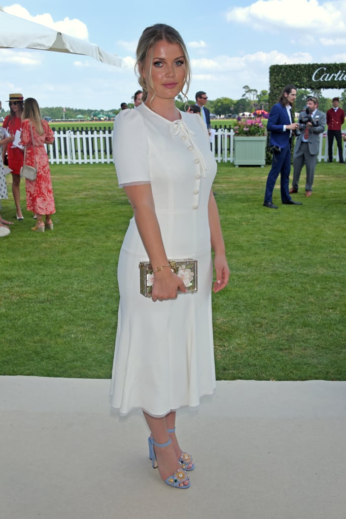 For the Cartier Queen's Cup polo final in 2017, Kitty wore a white midi dress with a box clutch and blue heels.