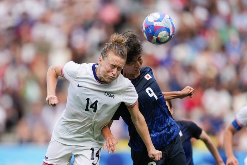 PARIS, FRANCE - AUGUST 03: Emily Sonnett #14 of the United States goes up for a header with Riko Ueki #9 of Japan during extra time of the Women's Quarterfinal match during the Olympic Games Paris 2024 at Parc des Princes on August 03, 2024 in Paris, Fran