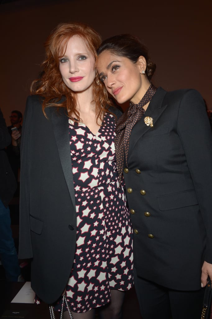 Salma Hayek cozied up to Jessica Chastain at the Saint Laurent show.