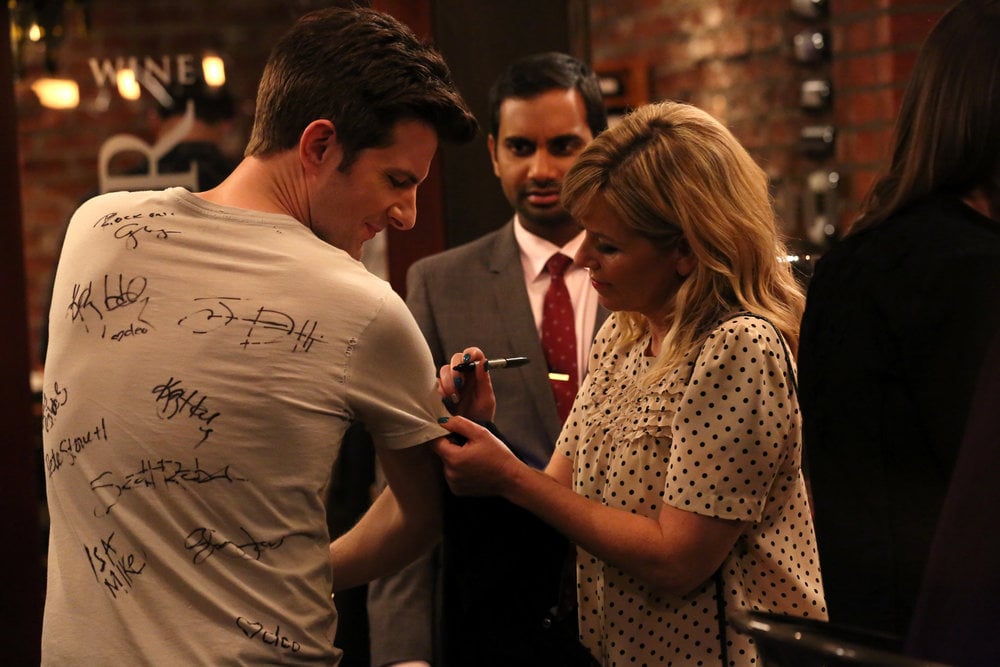 Some girl signs Ben's shirt.