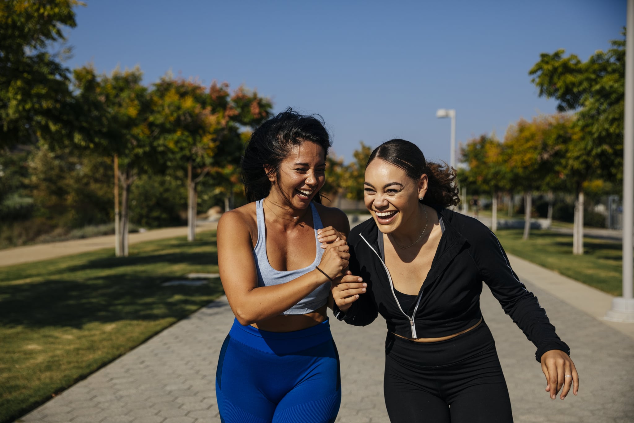 Two young women laughing and spending time outside in nature