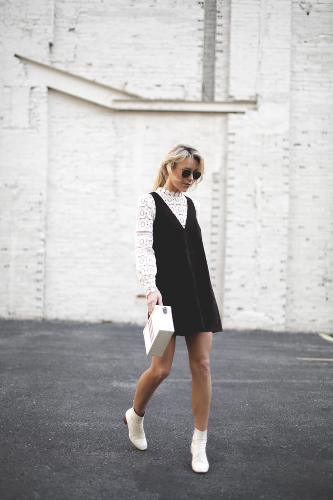 A lace top under a suede tank dress and boots.