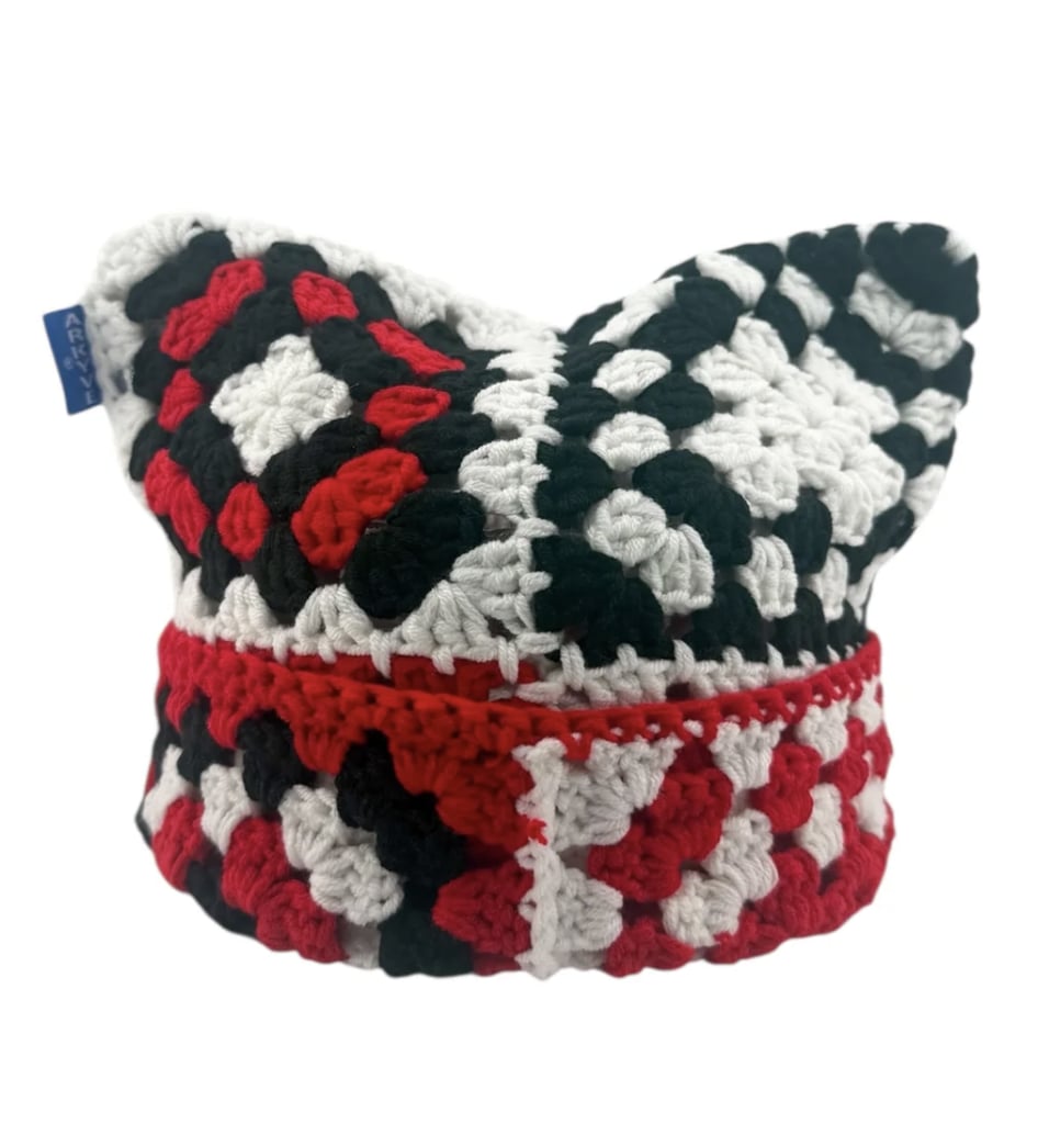 Arkyve Scarlet Crochet Cat Hat ($59)
I love discovering independent brands, especially since I prefer pieces no one else is wearing. Arkyve's crochet hat stands out with its red, black, and white color play, and its 100 percent acrylic yarn ensures durability. The cat-ear-inspired shape also adds a playful element I'm obsessed with, making this a versatile statement piece I'll reach for all season. It's equal parts edgy and sustainable.