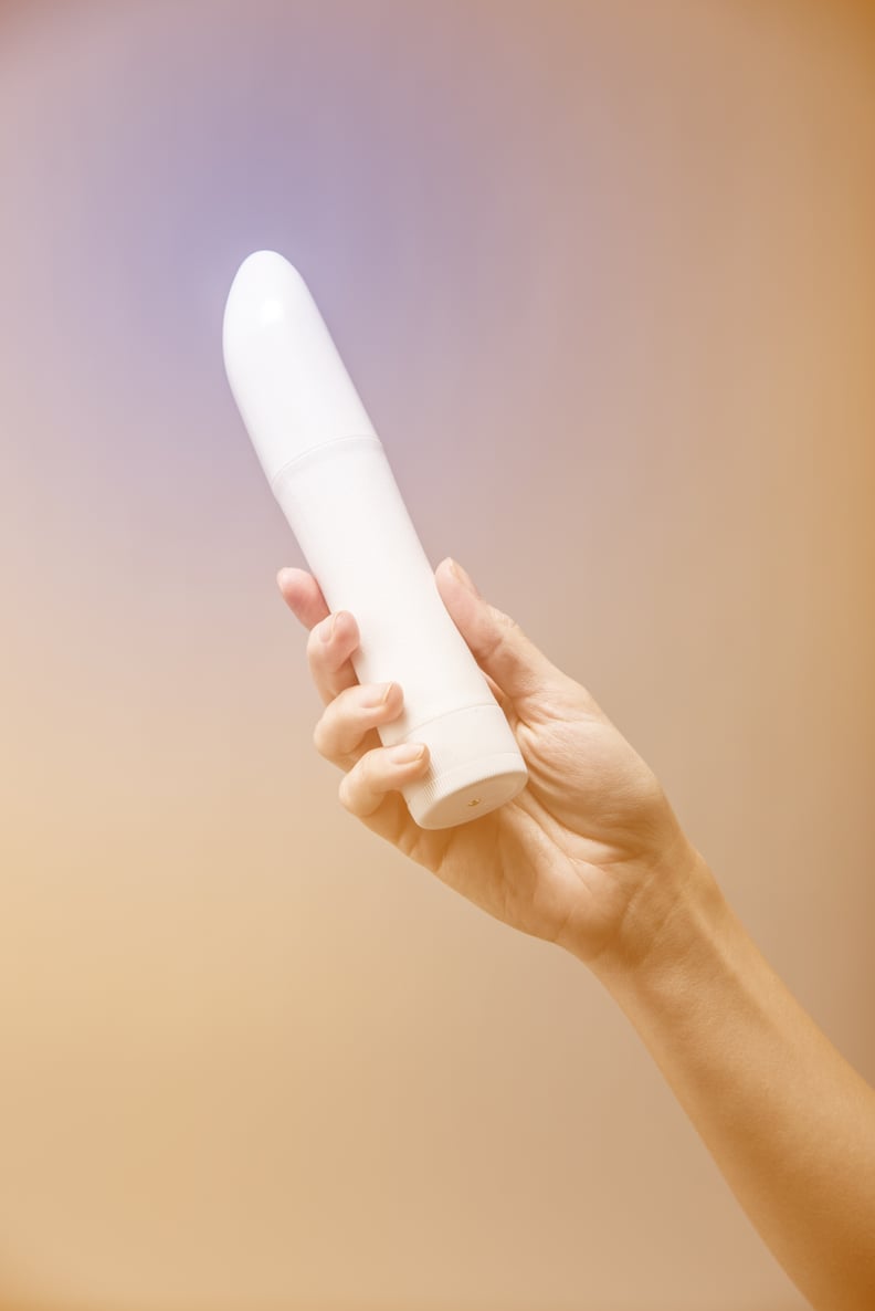 Woman's Hand Holding Vibrator Up