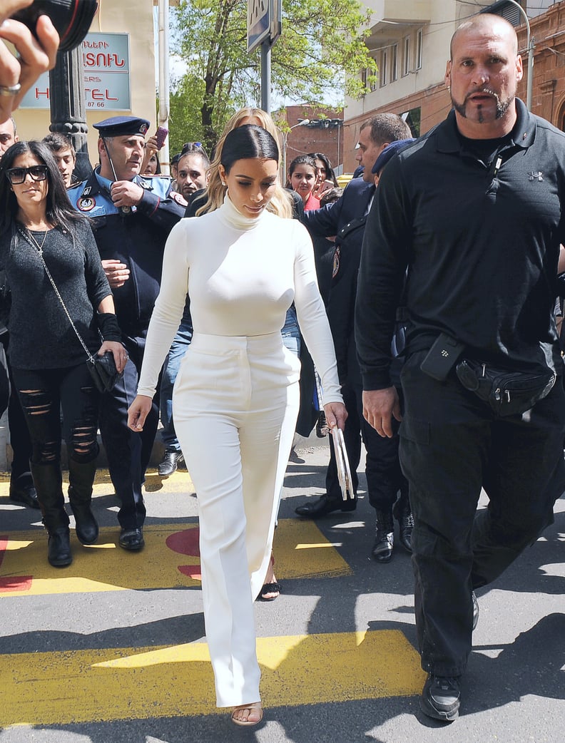 Kim covered up in white pants and a matching turtleneck.