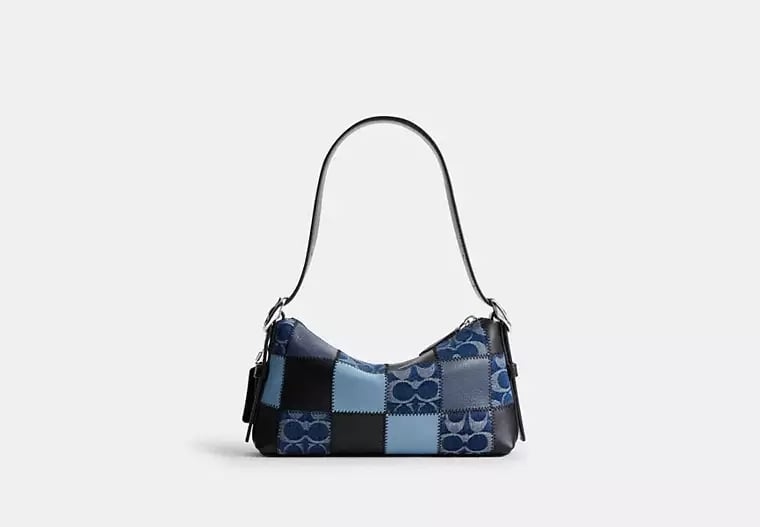 Coachtopia Alter/Ego Small Slouchy Shoulder Bag ($195)
Concert bags can be tricky, but this one hits every mark in both function and fashion. Pack your phone, portable charger, and shimmery lip gloss in this denim patchwork shoulder bag. To make the finished look even more festive, add a bright Coachtopia Cherry Bag Charm ($20) that is oh-so-Harry-coded.