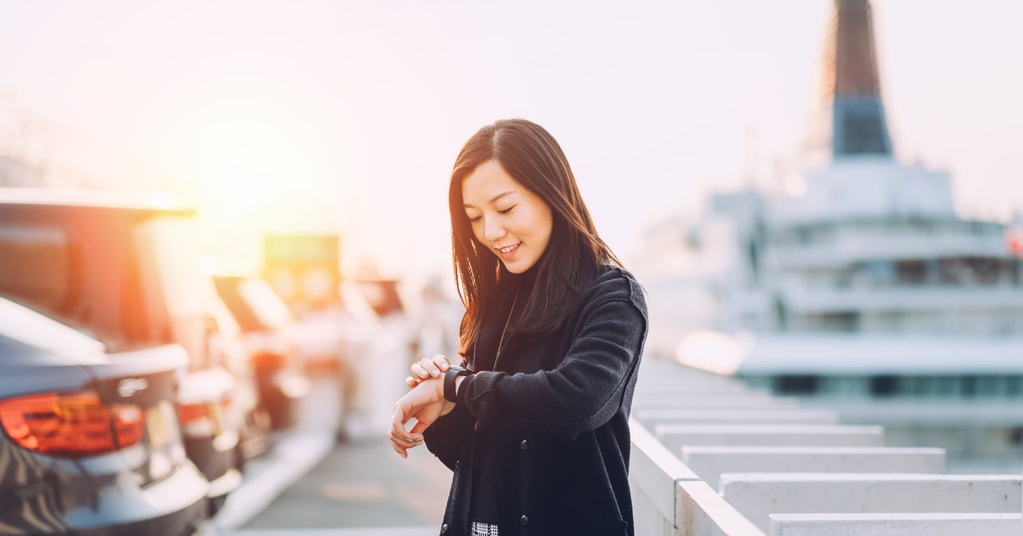 Young businesswoman checking her smart watch in city by the cruise terminal