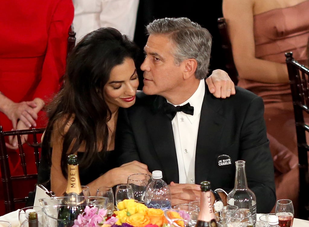 Amal Alamuddin cuddled up to George Clooney.