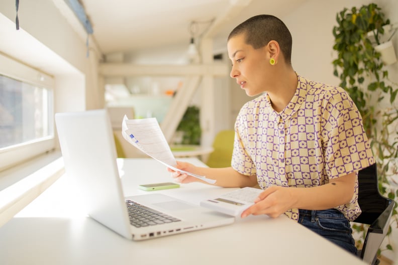 Young woman paying bills