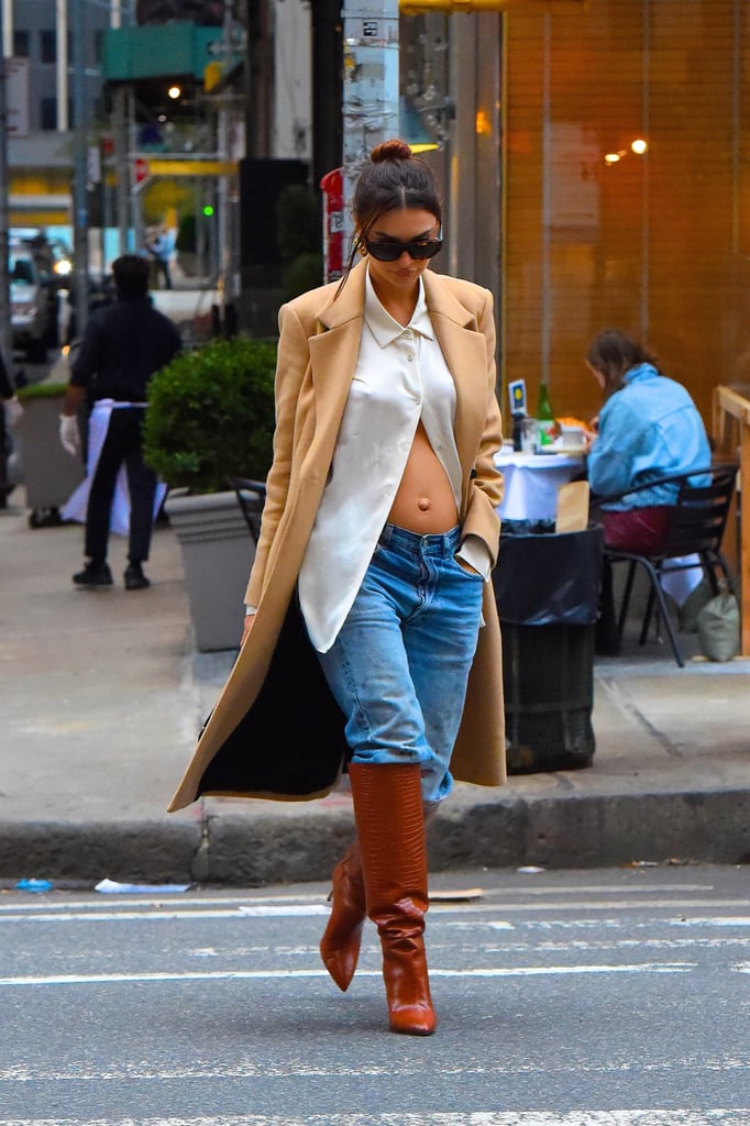 Leaving her white Uniqlo button-down open to show off her bump.