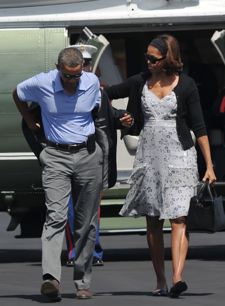 Michelle wearing a gray floral tiered dress and a wide headband in Florida.