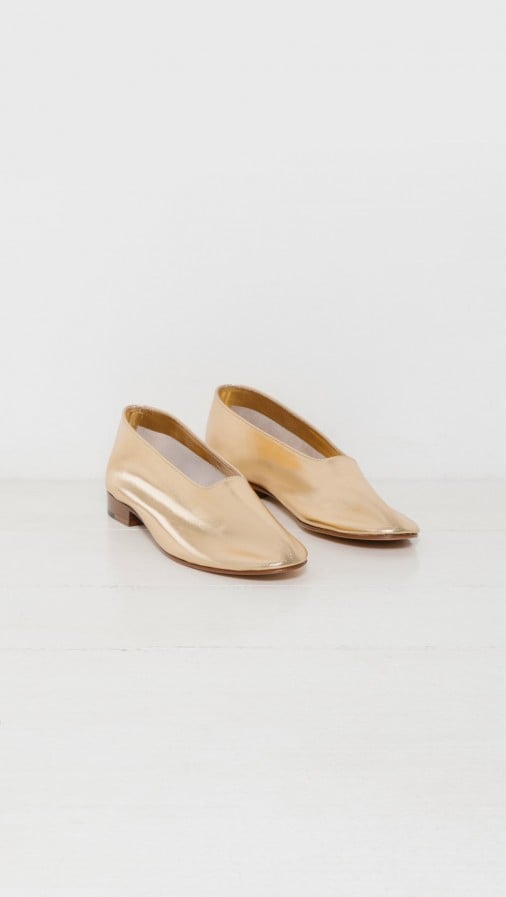 "'They fit like a glove' is how I would describe these golden flats ($430). The shoes are simple enough to wear with your everyday outfit, while the metallic sheen makes them anything but ordinary." — ML