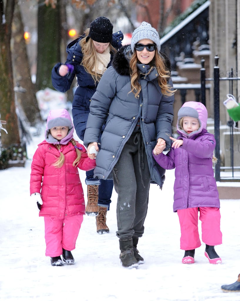 Sarah Jessica Parker walked with her daughters, Tabitha and Marion, on a snowy sidewalk in NYC in December 2013.