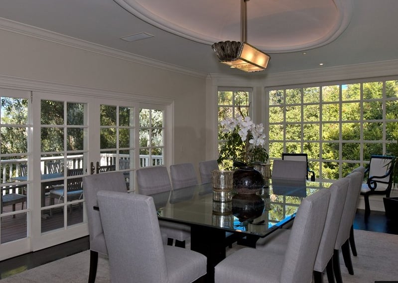 The spacious dining room includes floor-to-ceiling windows that allow for incredible views of the surrounding oak trees.