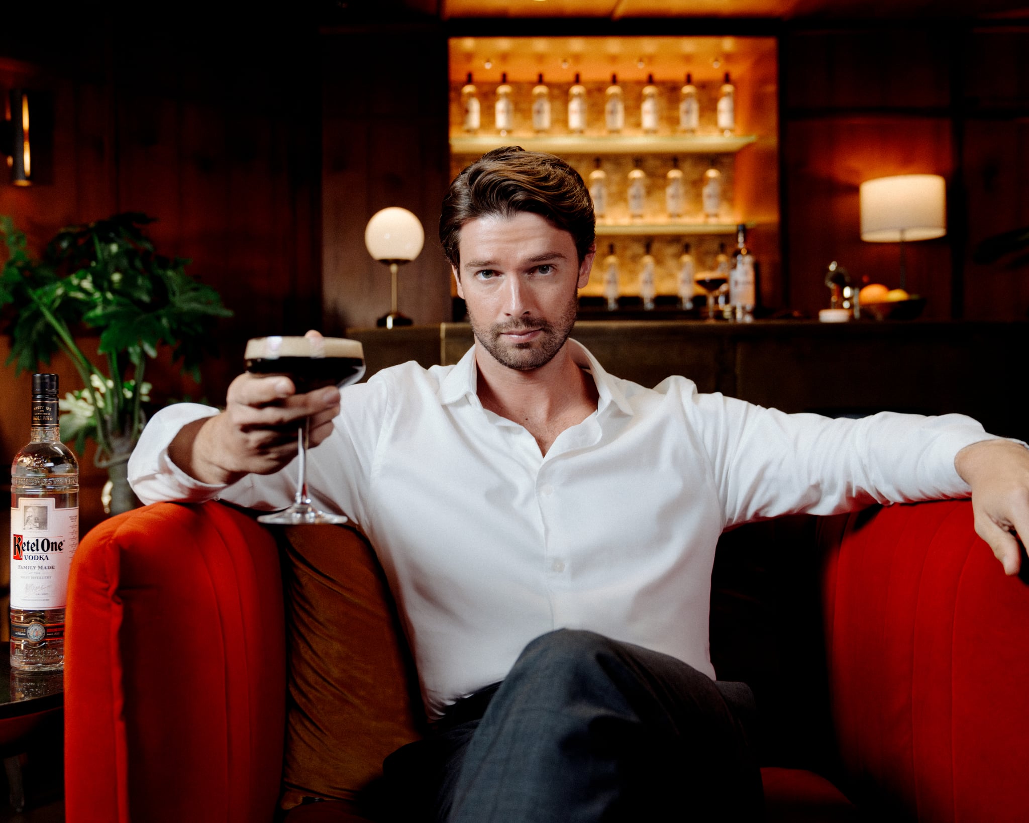 Patrick Schwarzenegger holding an espresso martini