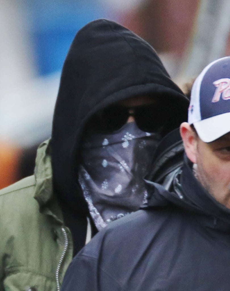 Meanwhile, Reynolds covered his face while walking on the set.