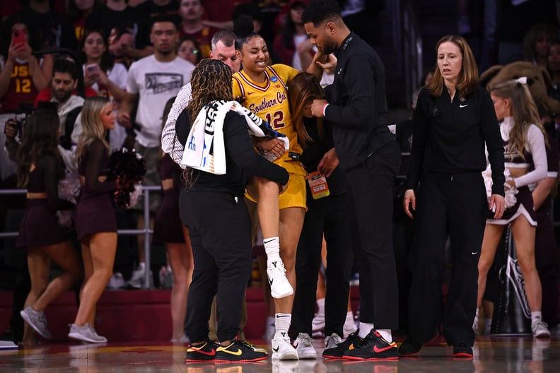 JuJu Watkins is helped up off the floor after being injured against the Mississippi State Bulldogs.