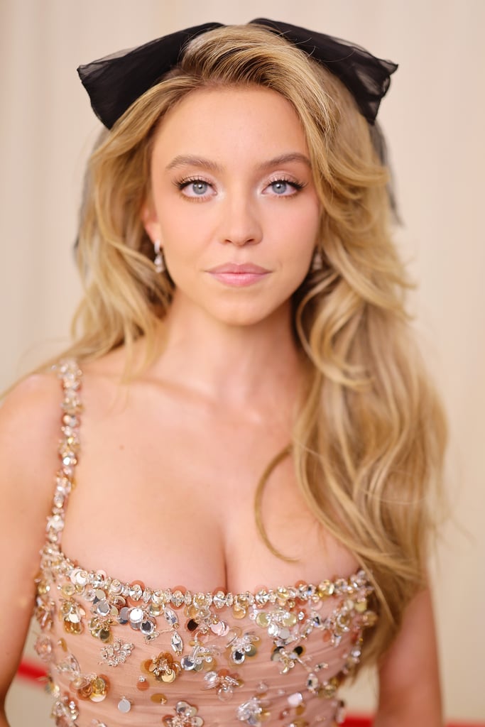 Sydney Sweeney's Voluminous Curls and Bow Hairstyle