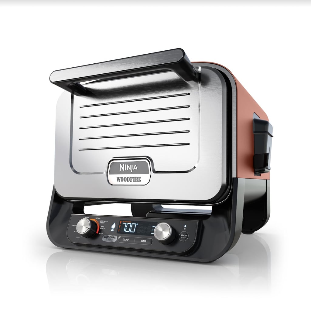 Ninja Woodfire 8-in-1 Outdoor Oven ($270, originally $400)
Ninja's latest cooking innovation is an impressive wood-fired outdoor oven. The electric heat can range from 105-700°F with eight different functions: pizza, max roast, specialty roast, broil, bake, smoker, dehydrate, and keep warm. It might look smaller than a regular oven, but it can fit plenty: up to a 12-pound turkey, a full sheet pan meal, a nine-pound pork shoulder, and more. There is an integrated smoke box on the side of the oven to add Ninja's real wood pellets that instantly infuse food with that wood-fired flavor.
Editor Quote: "If you like to entertain, this outdoor oven is an absolute must. The fact that you can make both homemade pizzas, a rack of ribs, or brownies in the same device is beyond impressive. I was lucky enough to test out the product, and not only did all types of foods cook faster than they would have in a traditional oven, but there was zero compromise on taste or quality. As a pizza-lover, my favorite feature is that the product can make either New York style, Neapolitan, thin crust, pan, or frozen on the pizza stone in under three minutes. The options are limitless!" — Perri Konecky, former associate breaking news director