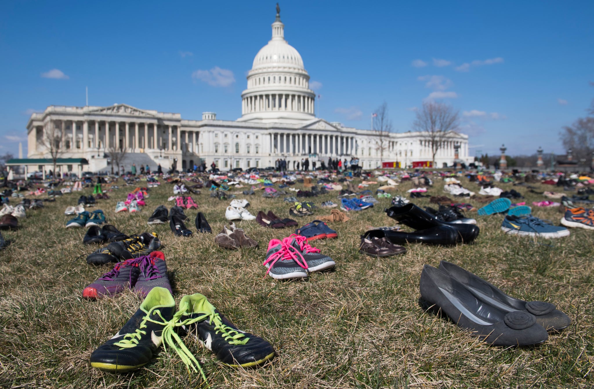 The lawn outside the US Capitol is covered with 7,000 pairs of empty shoes to memorialize the 7,000 children killed by gun violence since the Sandy Hook school shooting, in a display organised by the global advocacy group Avaaz, in Washington, DC, March 13, 2018. / AFP PHOTO / SAUL LOEB        (Photo credit should read SAUL LOEB/AFP/Getty Images)