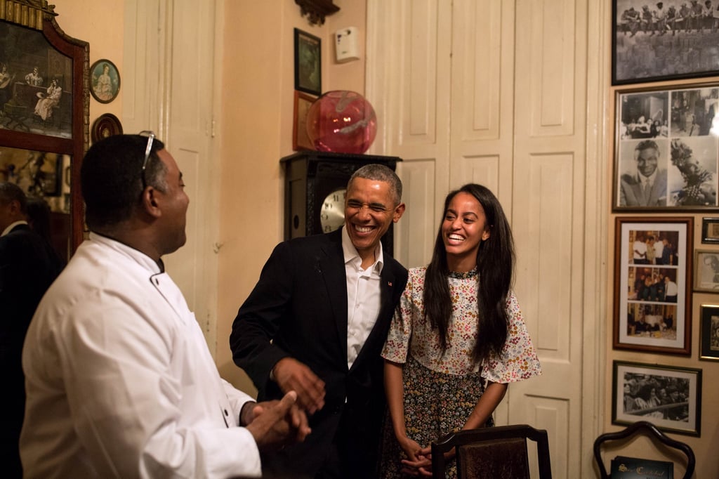President Obama and Malia laugh as Malia translates in Spanish for a restaurateur.