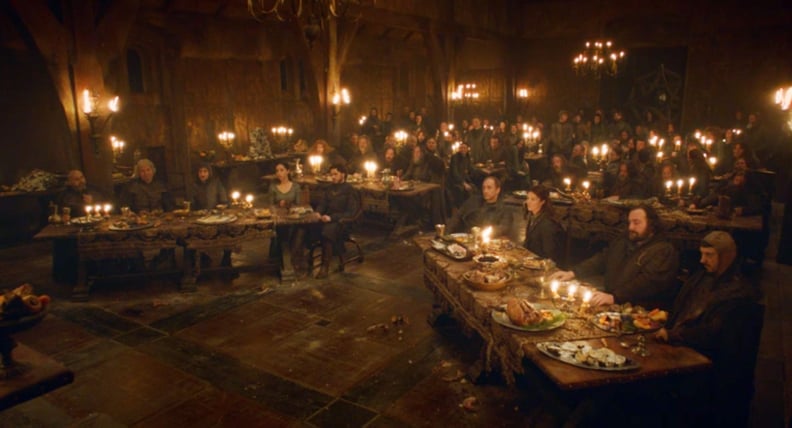 Two rows of candlelit banquet tables at the Red Wedding