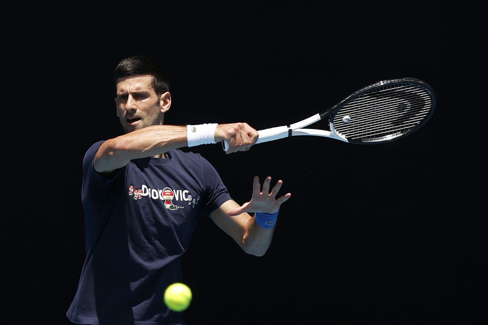 MELBOURNE, AUSTRALIA - JANUARY 12: Novak Djokovic of Serbia plays a forehand shot during a practice session ahead of the 2022 Australian Open at Melbourne Park on January 12, 2022 in Melbourne, Australia. (Photo by Darrian Traynor/Getty Images)