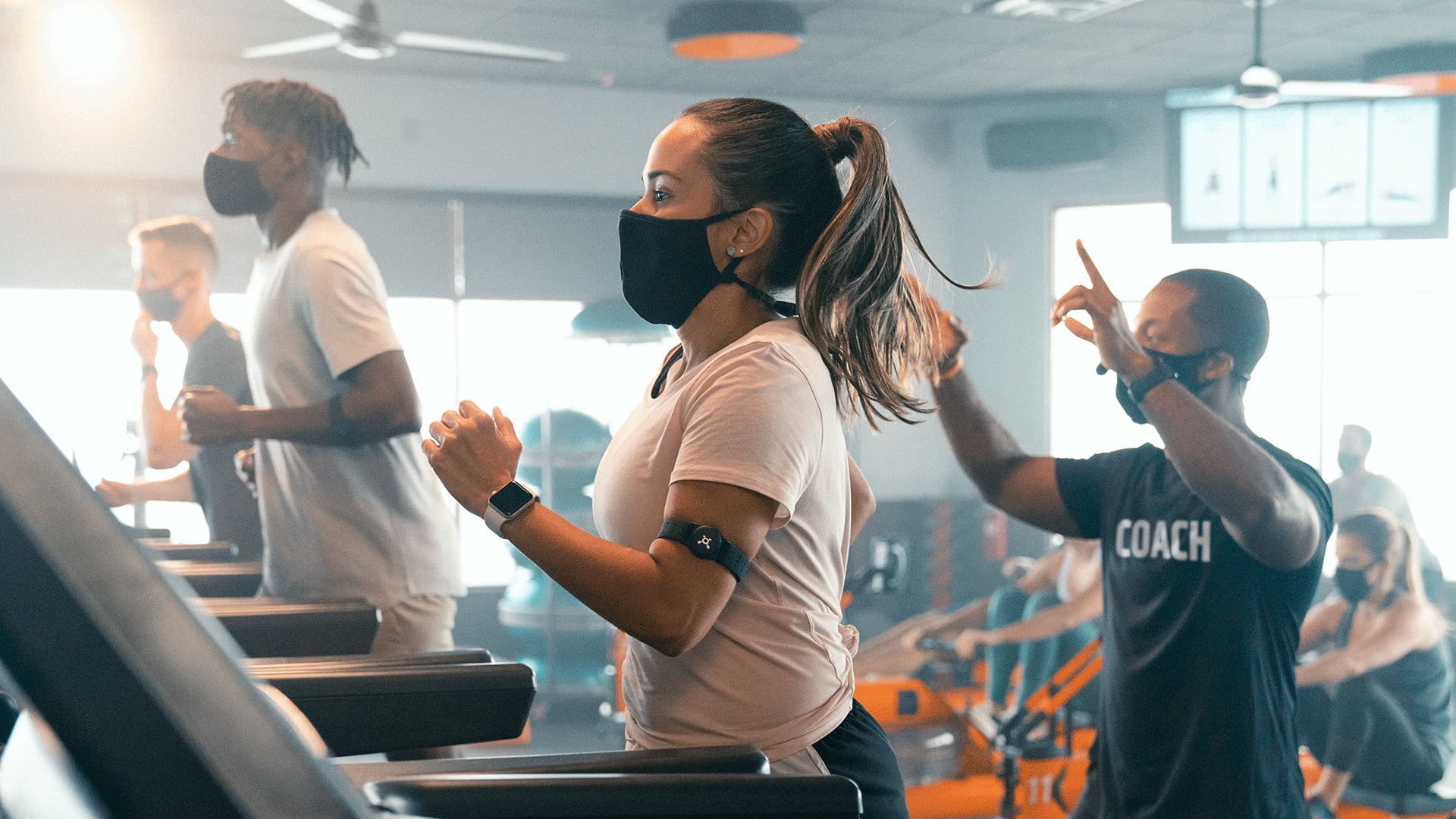 people doing orangetheory infinity workout on treadmill
