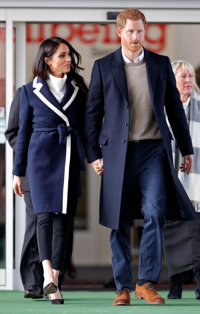 During a visit to Birmingham, Prince Harry wore a taupe sweater underneath a navy coat, which matched with Meghan's J. Crew piece.
