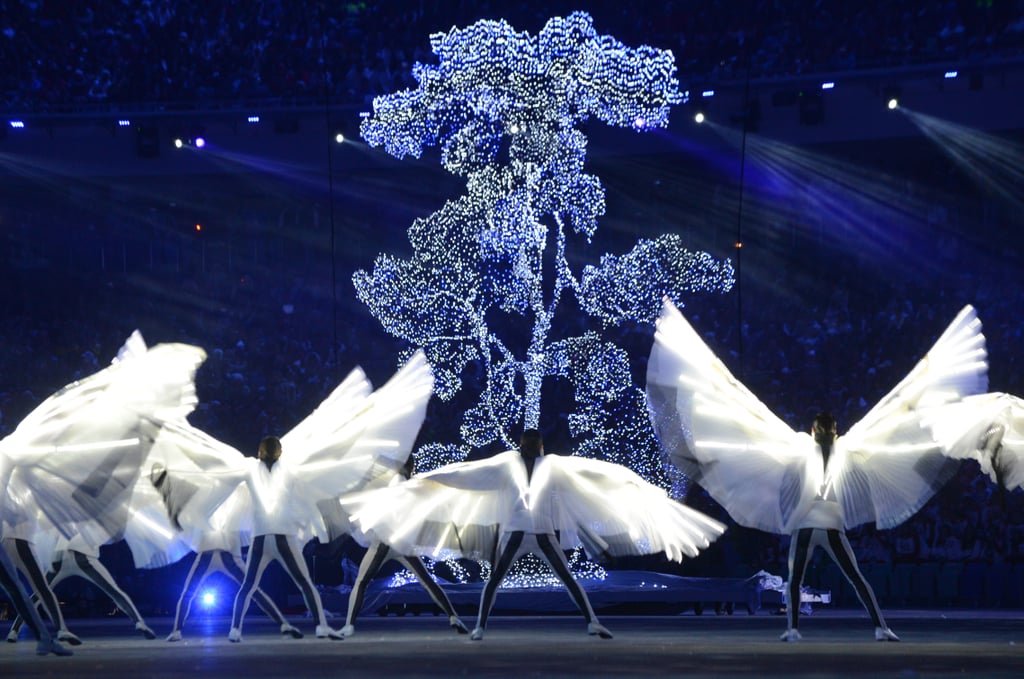 The winged artists danced beside glowing trees.