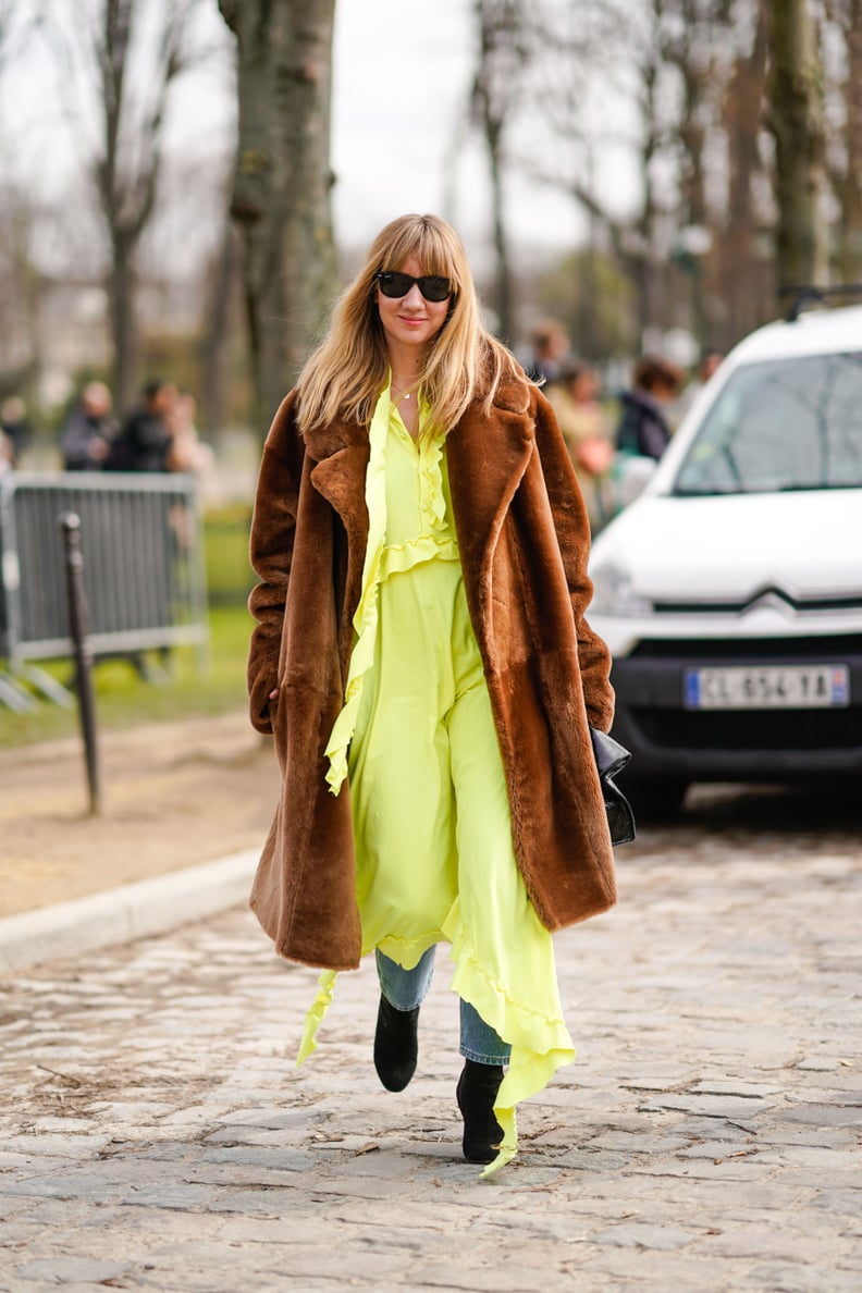Style a Neon Dress With Jeans and a Brown Coat