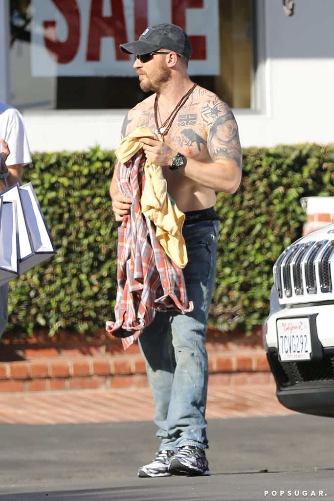 Imagine it: you're walking in a parking lot in LA when you suddenly see hot British actor and known puppy-lover Tom Hardy walking around shirtless. Well, that's exactly what happened when Tom and a friend hit up a Ron Herman store in LA on Sunday and the actor decided to strip off his top to change right in the middle of the street. The actor is back in LA after doing a whirlwind press tour for his latest release, The Drop, which hit theaters on Sept. 12. Now, Tom is gearing up for his latest project, The Revenant, which is set to begin filming very soon. The Revenant has been getting a lot of attention lately, as Leonardo DiCaprio will make his return to the big screen on the project after taking a short filming hiatus. According to The Hollywood Reporter, The Revenant may be the last Leo film for some time, as the actor plans to take "a lengthy break from acting" once he finishes up filming.