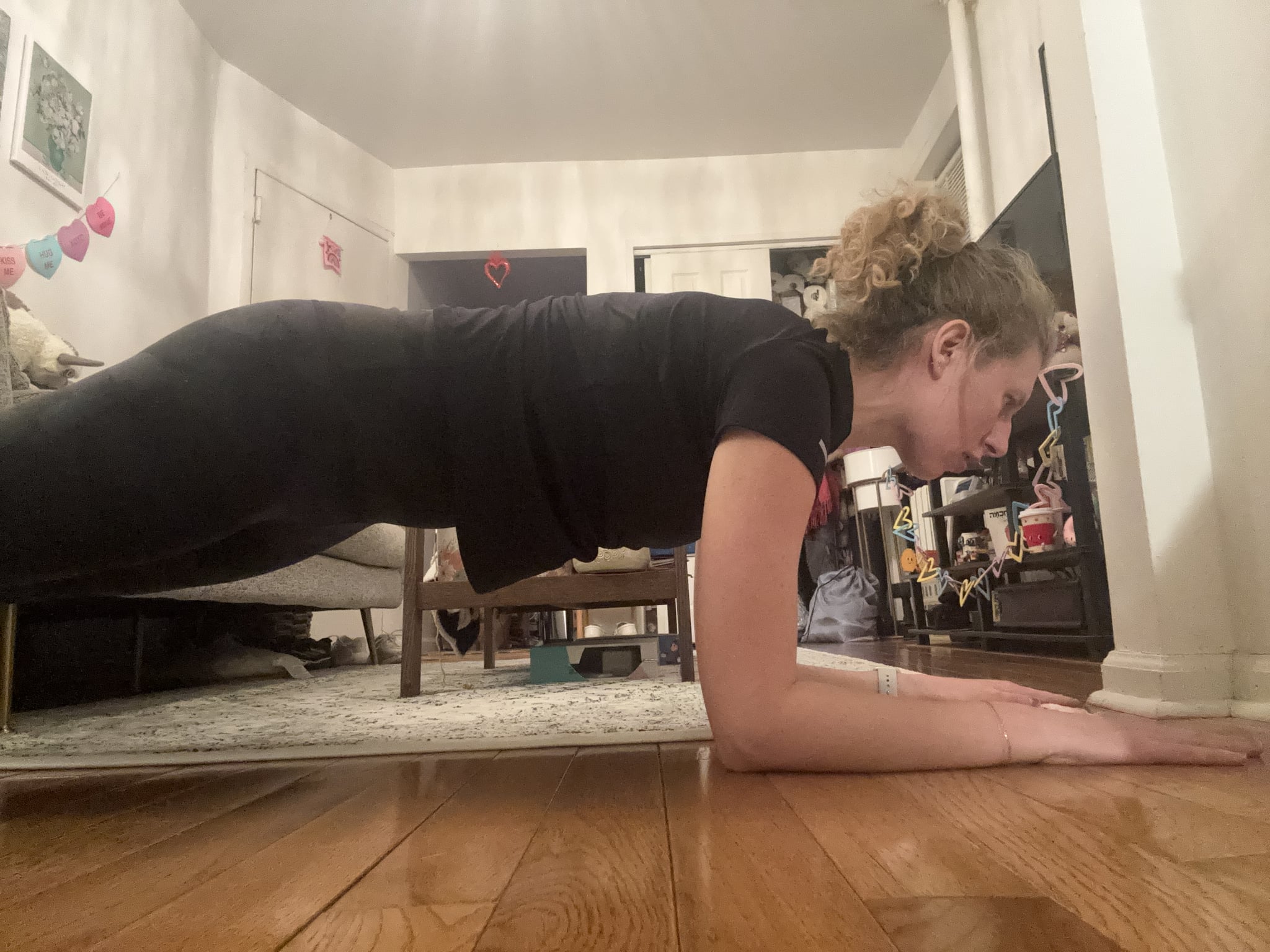 Courtney Campbell doing a plank exercise in her home.