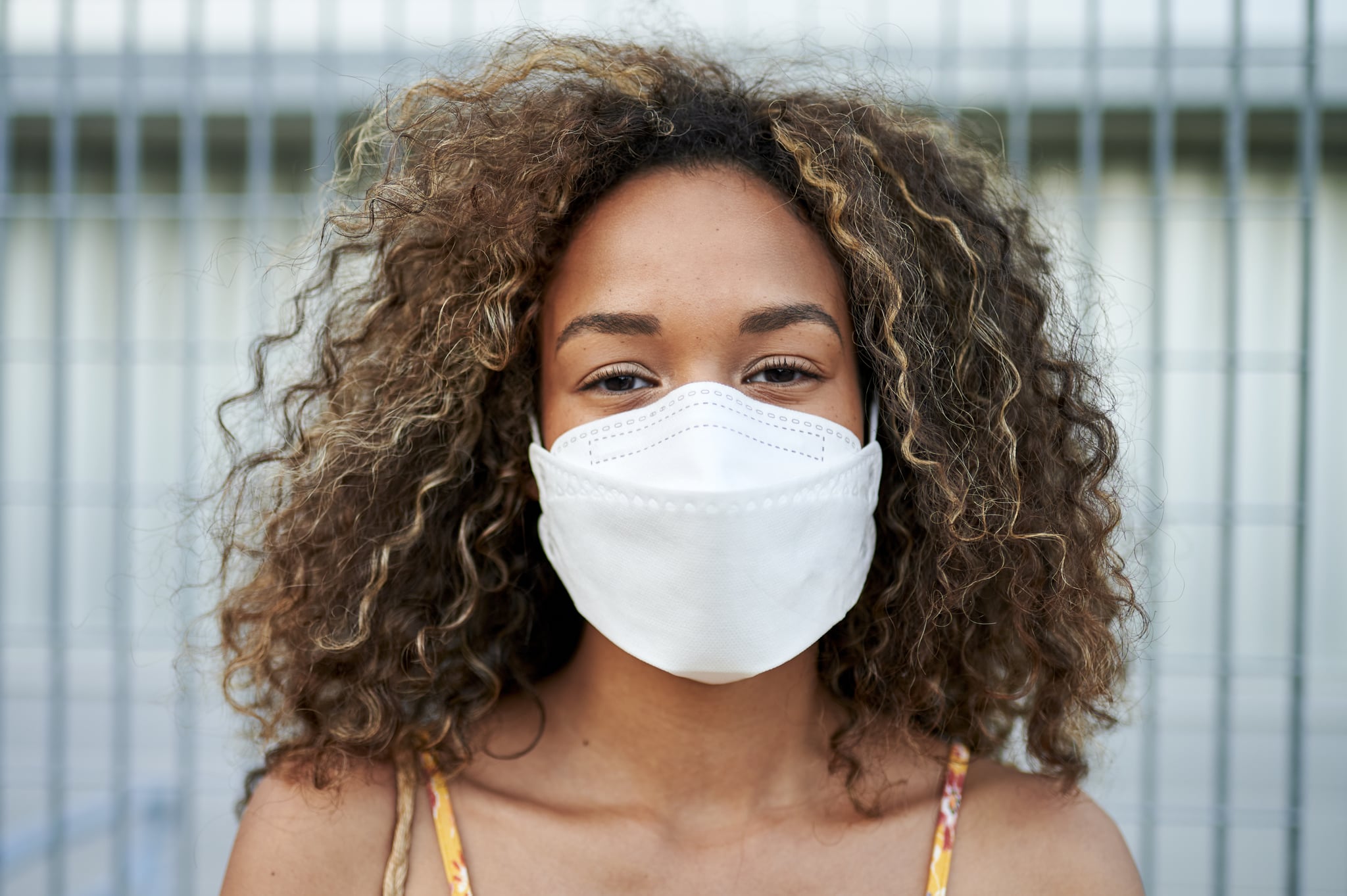 Woman wearing surgical mask, preventing against COVID-19.