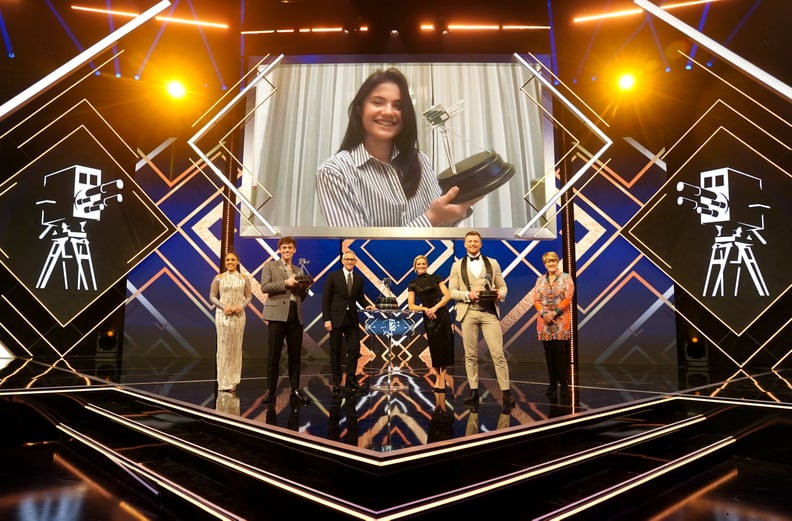 Emma Raducanu (video-link) poses with her Sports Personality of the year award alongside (left-right) Alex Scott, Second placed Tom Daley, Gary Lineker, Gabby Logan, Adam Peaty and Clare Balding during the BBC Sports Personality of the Year Awards 2021 at