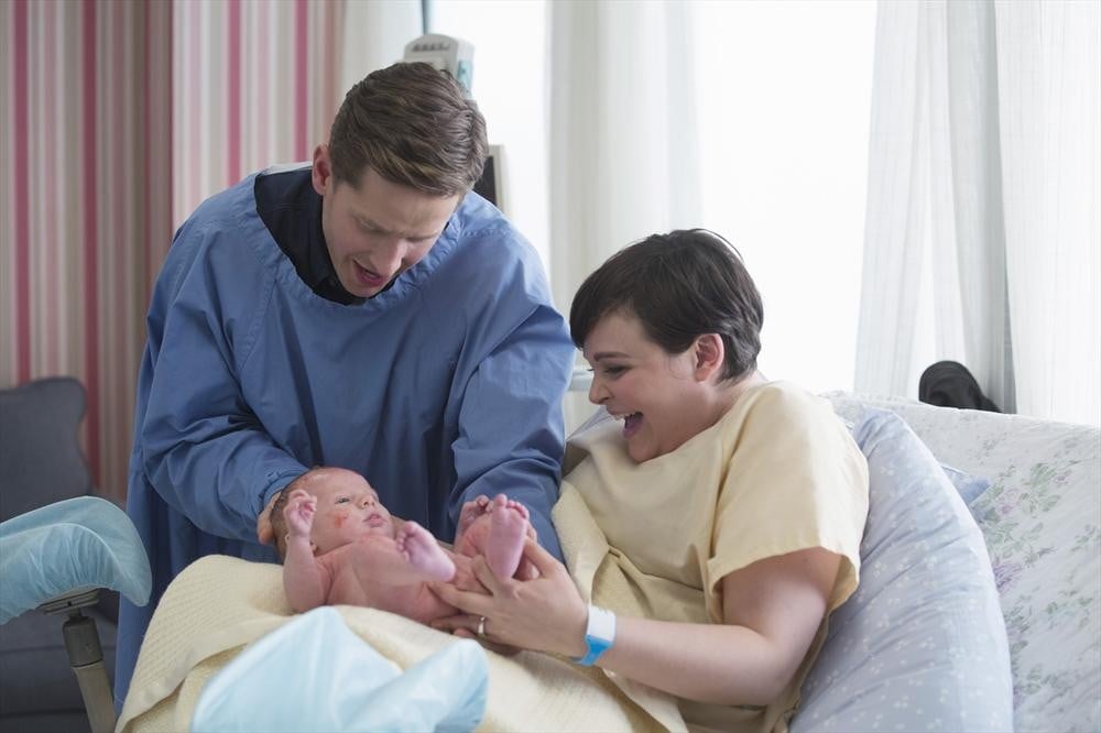 Aw, Mom, Dad, and baby look healthy and happy.