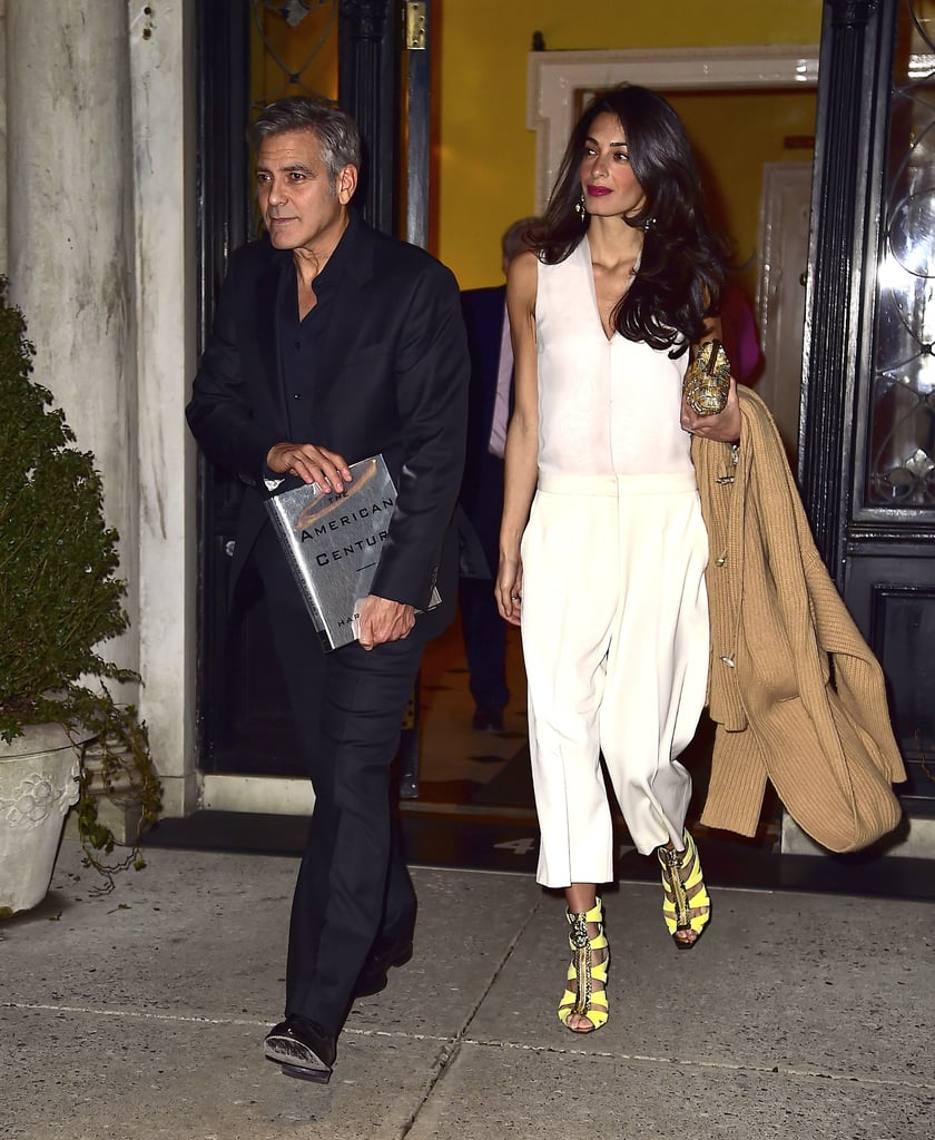 Amal ditched the dress for date night with George, selecting a chic, functional white Stella McCartney jumpsuit instead. She completed her look with bright eye-catching heels, then played up their yellow shade with golden accessories: a metallic clutch and geometric drop earrings.