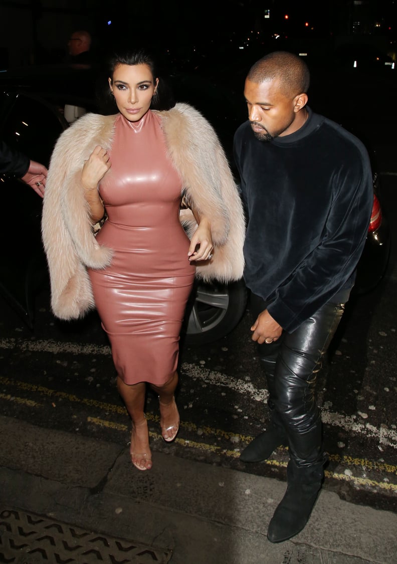 Kim suited up in latex in London, but Kanye played it cool.