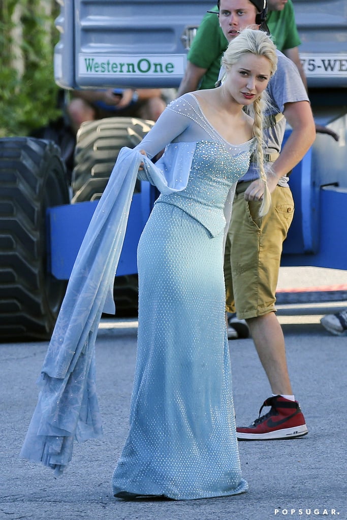If you were excited about Frozen coming to Once Upon a Time before, get ready to freak out. Georgina Haig was seen in costume as Frozen's Elsa in season four while filming scenes for the show on the Vancouver set on Wednesday. While she wasn't throwing ice or snow around, she definitely looked the part. Also on Wednesday, the cast (minus Georgina) was spotted filming scenes. We'll have to wait and see when Anna and Kristoff show up, which could be in flashbacks in Arendelle or in present-day Storybrooke, where Elsa was transported to at the end of season three. Hopefully we'll see other characters soon — as well as many other things from the Frozen movie on Once Upon a Time.